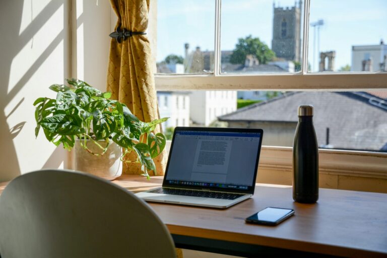 A laptop and phone on a desk