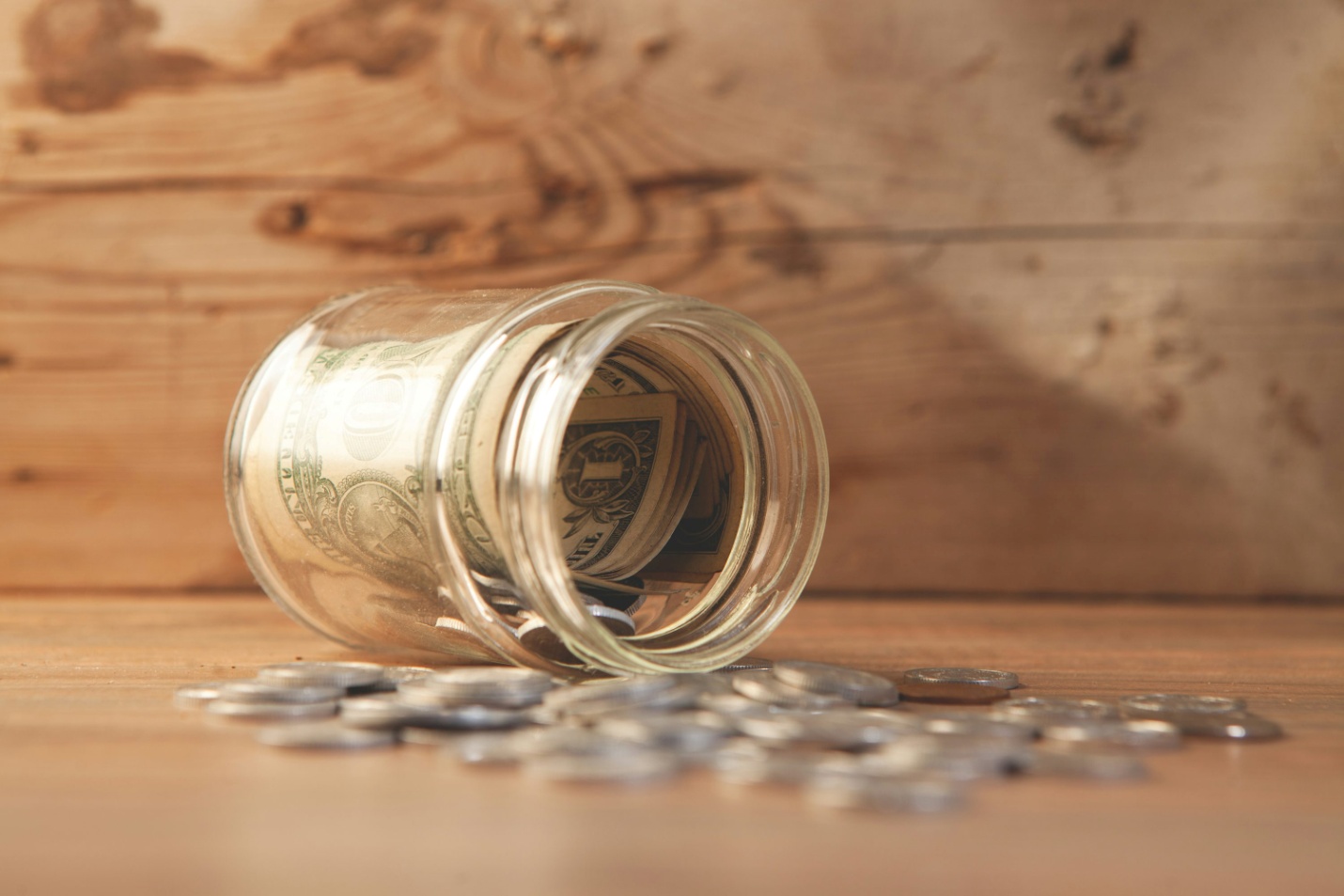 A jar of money spilled on the floor